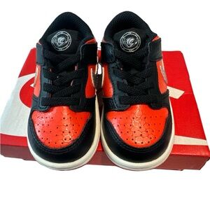 Baby black and orange Nike shoes, size 5c.